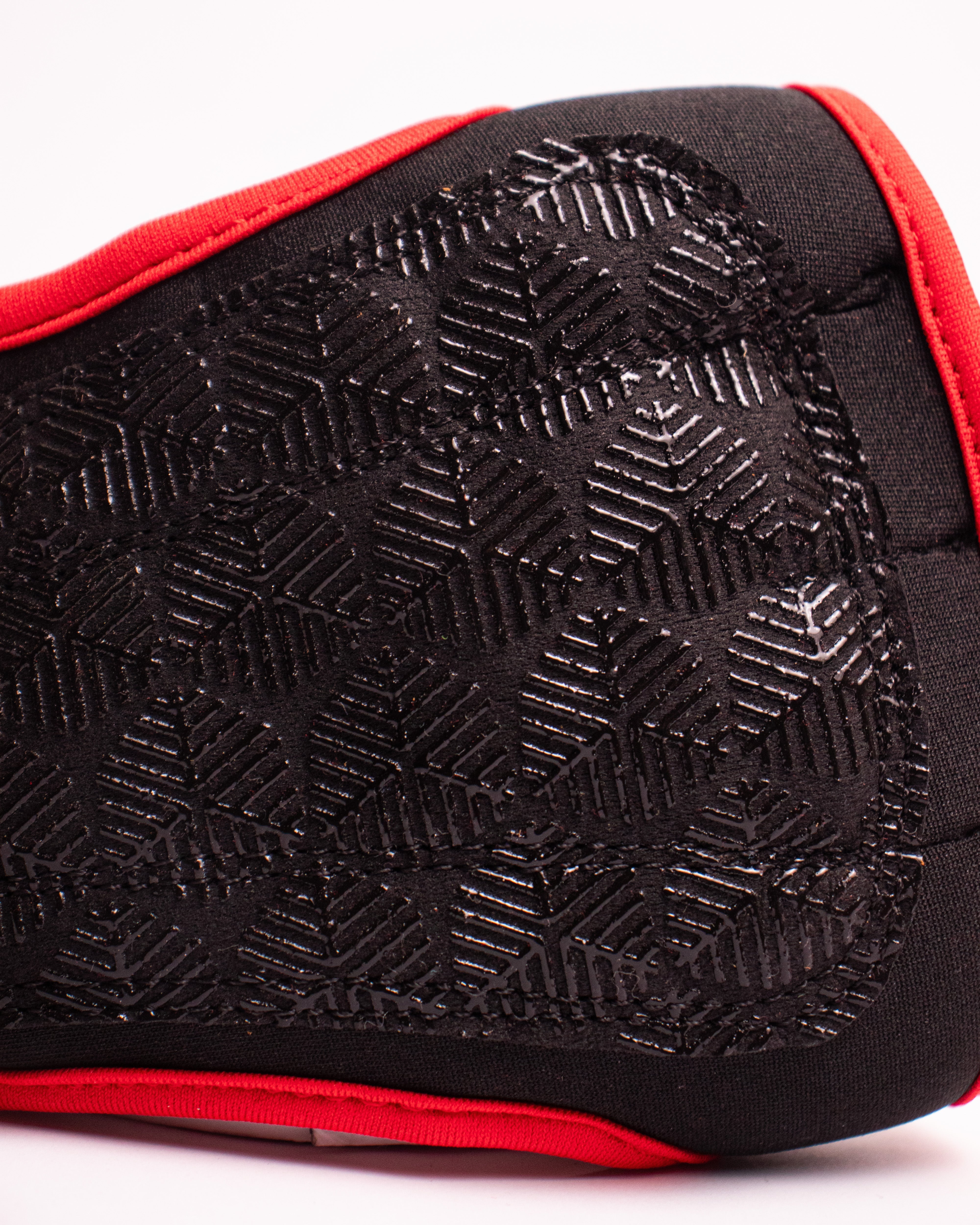 Close-up of a black and red knee pad with textured surface