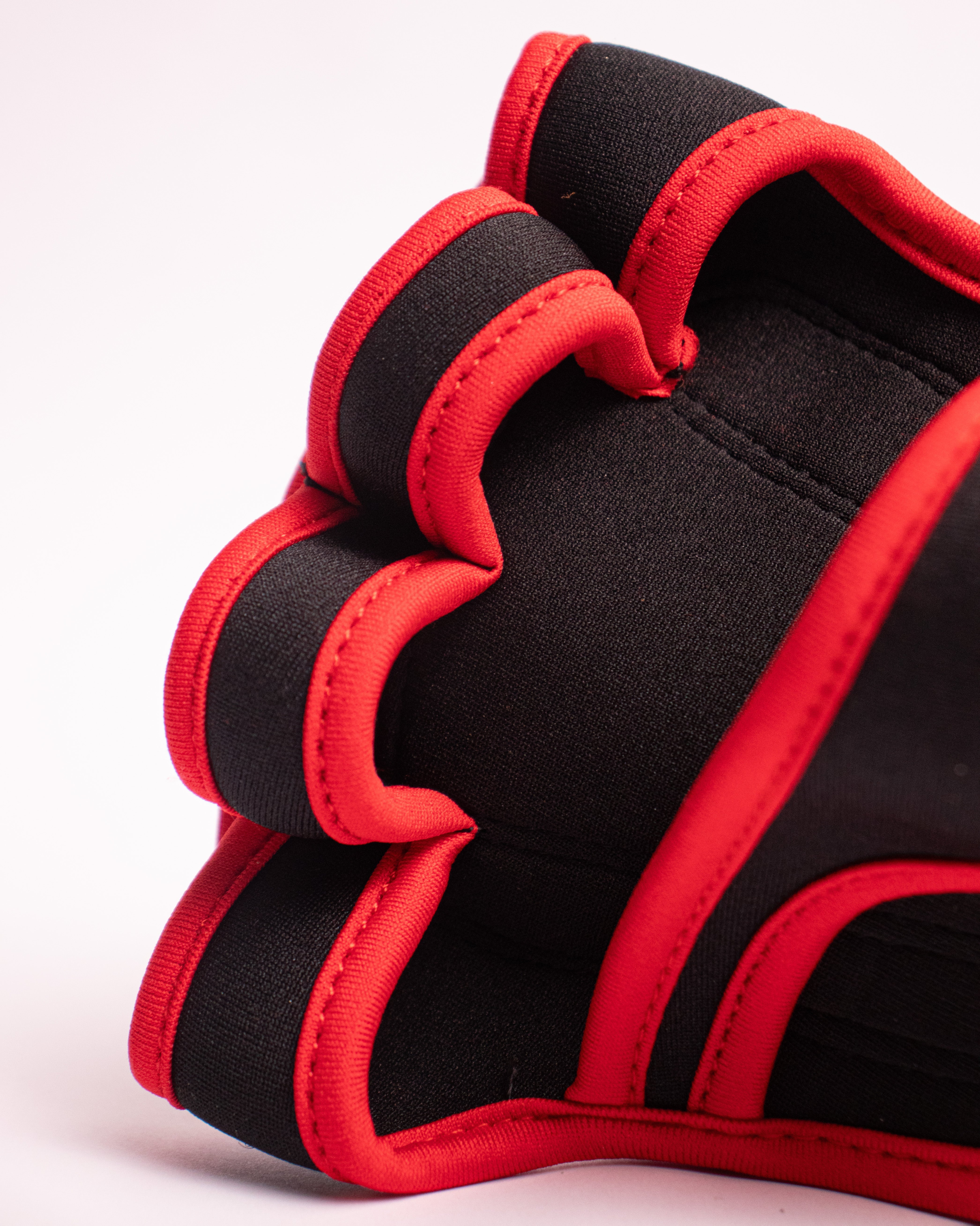 Black and red athletic glove on a white background